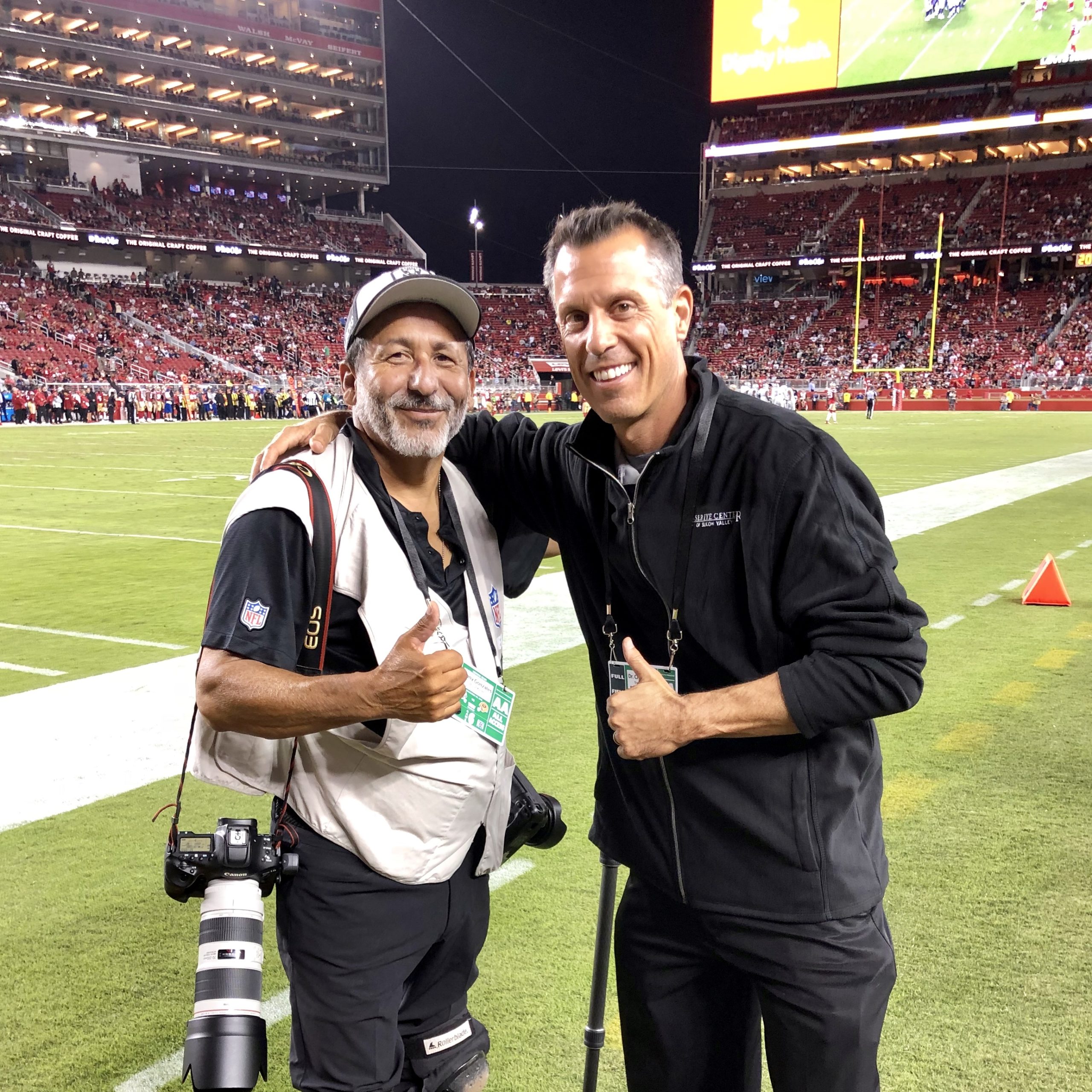 Dr. Craig Bindi & LEC Patient together on a football field