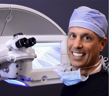 Dr. Craig Bindi next to microscope
