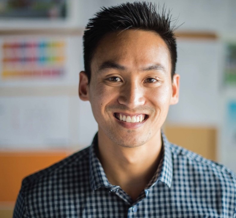 Man smiling wearing checkered shirt