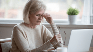 Woman in front of her computer rubbing her eyes - LASIK: How To Treat Dry Eyes