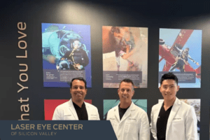 Dr. Joseph J. Ling, Dr. Craig S. Bindi & Dr. Sudhinder Koushik smiling in front of LEC's Do What You Love wall