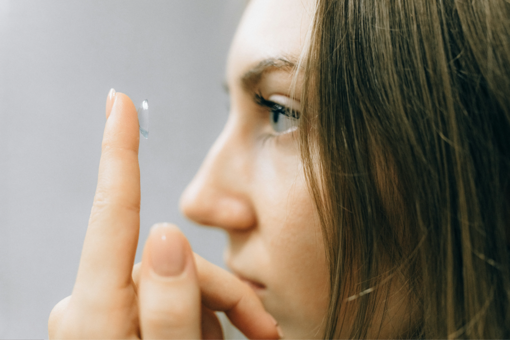 Woman applying contact lens